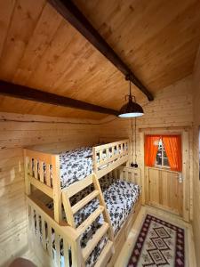 a bedroom with two bunk beds in a log cabin at Dream House in Batumi