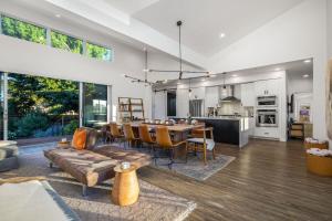 a living room with a couch and a dining room at Luxury Villa Year-Round Heated Pool Hot Tub Fire Pit Lawn in Kenwood