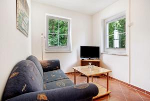 a living room with a couch and a table at Haus Seeadler Wohnung 8 in Ostseebad Koserow