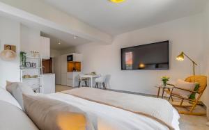 a bedroom with a bed and a flat screen tv at Studio Percan in Premantura