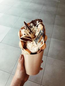a person is holding a cup of ice cream at Apartments Vesna Luxury & Stefan ap 4 in Paralia Katerinis