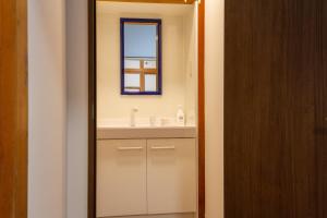 a bathroom with a sink and a mirror at SunRise STAY Atami Ajiro in Ajiro
