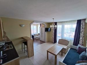 a living room with a couch and a table at Family Hotel Sofi in Sozopol