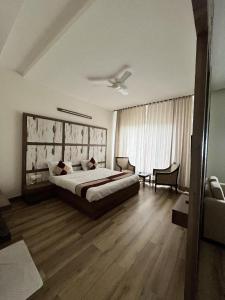 a bedroom with a bed and a ceiling fan at Rudraksh Resort and Hotel in Rewāri
