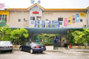 two cars parked in front of a building at Winggarden Murals House by JE Boutique Guesthouse in Ipoh