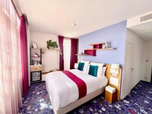 a bedroom with a large bed in a room at Hôtel Berria par La Maison de Pierre in Hasparren