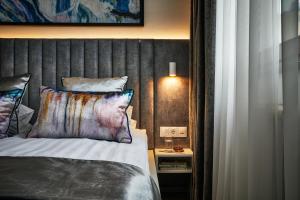 a bedroom with a bed with a wooden headboard at 7Seasons Apartments Budapest in Budapest