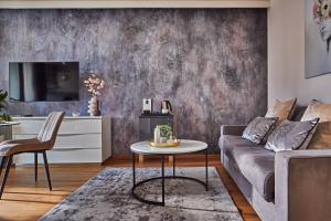 a living room with a couch and a table at 7Seasons Apartments Budapest in Budapest