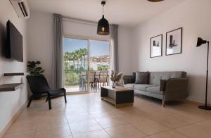a living room with a couch and a table at Phaedrus Living Limassol Pyrgos Seaside Flat in Limassol