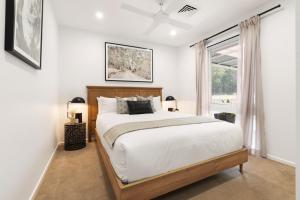 a bedroom with a large bed and a window at 'Avondale' Luxe Country Retreat in Pitt Town