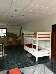 two bunk beds in a room with a kitchen at Loft Rural Barcelona in Barcelona