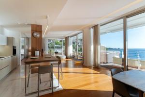 a kitchen and dining room with a view of the ocean at Luxury Waterfront Villa at Dukly Gardens in Budva