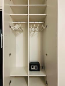 a walk in closet with a clock on the shelf at WHOLE HOUSE FOREST-yard and BBQ, private parking in Marinići