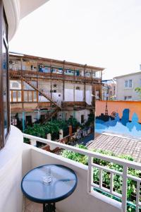 a balcony with a table and a view of a building at Hotel Imperial House in Tbilisi City