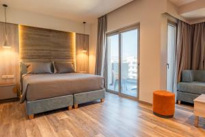 ein Schlafzimmer mit einem Bett und einem großen Fenster in der Unterkunft Wellnest Hotel in Athen