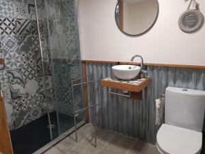 a bathroom with a sink and a toilet and a shower at La Toile sous Les Étoiles in Charron +53 photos