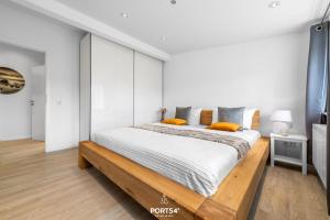 ein Schlafzimmer mit einem großen Bett mit weißen Wänden in der Unterkunft Ferienhaus Loft an der Ostsee Glücksburg in Glücksburg