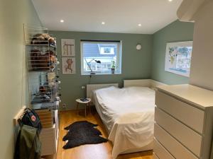 a small bedroom with a bed and a window at Modern villa i Sävedalen in Gothenburg