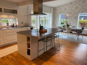 a kitchen with a large island in the middle of a room at Modern villa i Sävedalen in Gothenburg