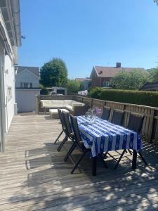 a blue and white table and chairs on a deck at Modern villa i Sävedalen in Gothenburg