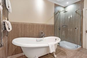 a bathroom with a tub and a shower and a sink at Taychreggan, Signature Collection by Eight Continents in Oban +60 photos
