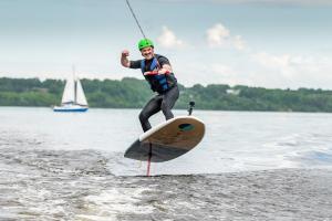 a man is being pulled on a board in the water at Monte Pacis in Kaunas