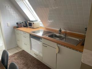 a small kitchen with a sink and a microwave at Zirndorf Ferienhaus in Zirndorf