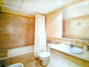a bathroom with a toilet and a sink and a mirror at Banana Beach in Marbella