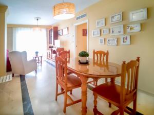 a dining room with a wooden table and chairs at Banana Beach in Marbella