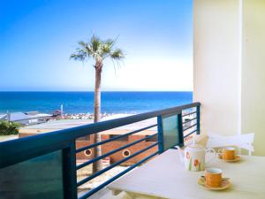 a table on a balcony with a view of the beach at Banana Beach in Marbella