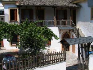 a house with a fence and a tree in front of it at Katerina's apartment in Keramídhion