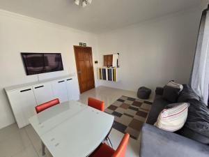 a living room with a white table and a couch at Stunning two bed apartment in St Pauls Bay Malta in St Paul's Bay