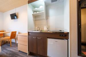 a kitchen with a sink and a counter top at RESI STAY Yasaka in Kyoto
