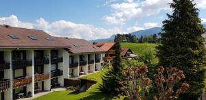 a view of a resort with mountains in the background at Haus Obermaiselstein in Obermaiselstein