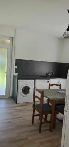 a kitchen with a table and a stove and a sink at au Bonhomme de Chemin in Saint-Martin-de-Ribérac +5 photos