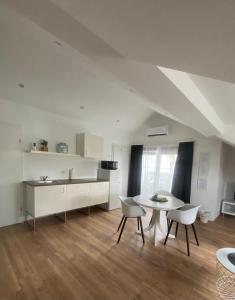 a kitchen and dining room with a table and chairs at Apartma Špela in Slivnica pri Mariboru