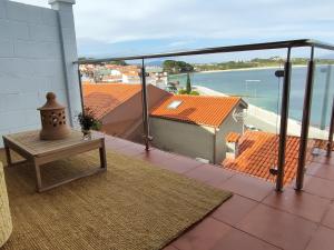 a balcony with a table and a view of the water at Casa Boa Vista in San Pedro