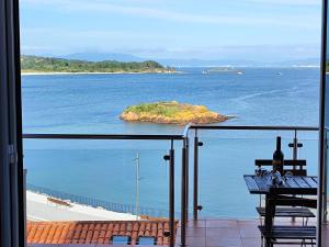 a view of an island in the ocean from a balcony at Casa Boa Vista in San Pedro