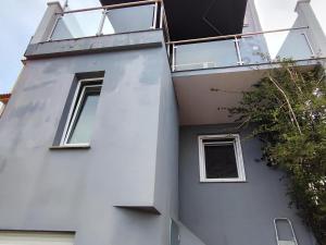 a white building with windows on the side of it at Casa Boa Vista in San Pedro
