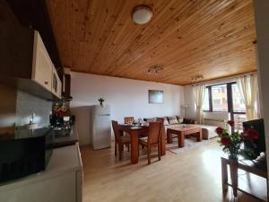a kitchen and living room with a table and a couch at Saphir apartment , Rhodopi Pearl Pamporovo in Pamporovo