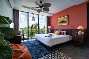 a bedroom with a bed and a large window at G Boutique Retreat Hoi An in Hoi An +51 photos