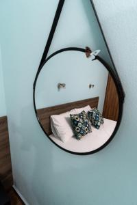 a mirror in a room with a bed and pillows at Villa Olympia in Paralia Katerinis +70 photos