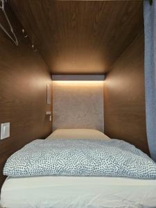 a bedroom with a bed with a wooden head board at Seoul Cube Myeongdong in Seoul
