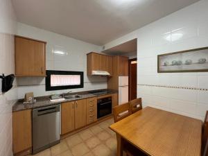 kuchnia z drewnianymi szafkami i drewnianym stołem z blatem w obiekcie La Casa del Sol ll by Best Holidays Fuerteventura w Corralejo +8 zdjęć
