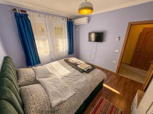 a small bedroom with a bed and a window at Dani Apartments, Albanian Alps, Tropoje in Kolgecaj