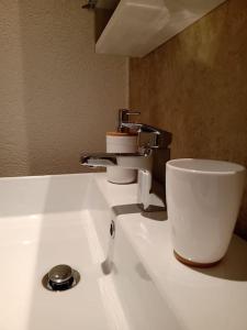 a white sink with a faucet on top of it at Salita al castello in Rossana +21 photos