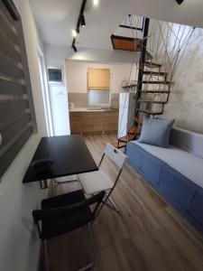 a living room with a blue couch and a table and chairs at Apartment Maya in Bijela