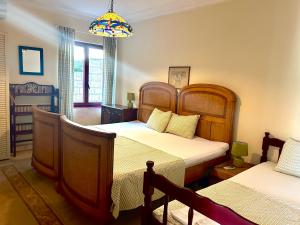 a bedroom with two beds and a chandelier at Guest House Vila Eli in Herceg-Novi +49 photos