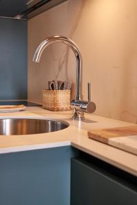 a kitchen sink with a faucet on a counter at Orti29 - Luxury Stay Bologna in Bologna