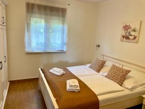 a bedroom with a large bed with towels on it at Mare E Sabbia in Lopar